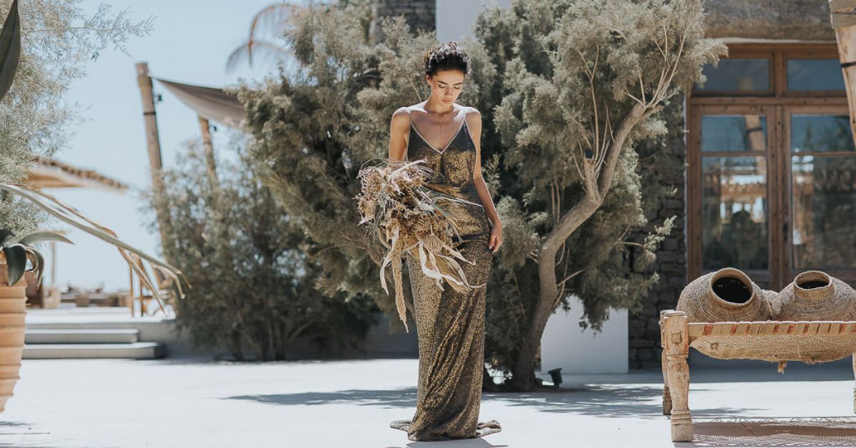 Elegant outdoor wedding ceremony at a luxury Mykonos villa with panoramic sea views, representing high-end destination weddings in Greece.